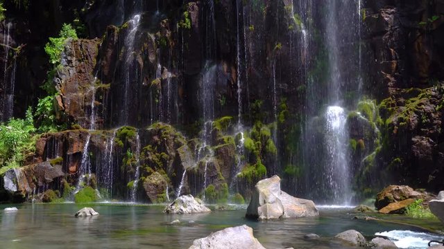 waterfall in a tropical forest on a sunny hot day. Georgia, waterfall Dashbashi.