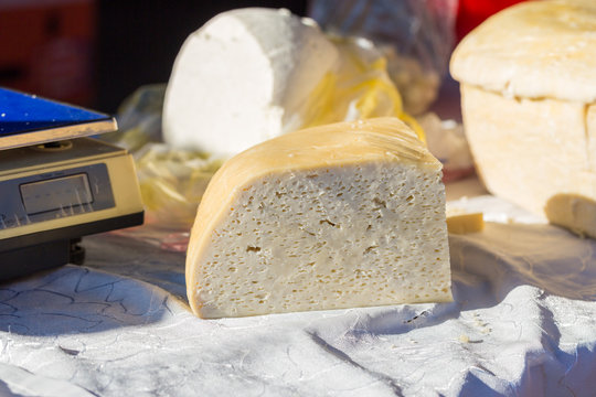 PRAID, ROMANIA - July 4, 2019: Traditional hungarian sheep cheese (telemea). On display for sale at a market. Salty taste, harghita, feta, milk, flavor, delicious, slice, rustic, dairy product, fresh.