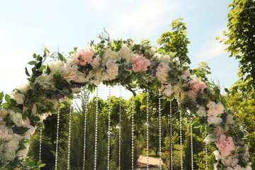 beautiful round wedding arch of fresh flowers. Wedding ceremony
