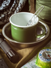 Traditional tourist equipment kit on khaki textile background