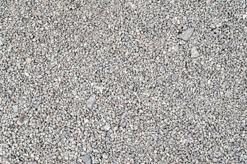 Gravel texture. Fine light gray granite stone gravel.