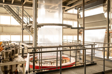 Workplace inside large modern manufacturing plant with processing equipment