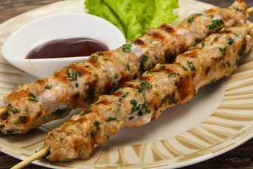 Minced pork skewer kebab with sauce