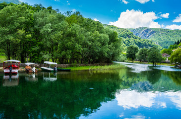 Montenegro, Many boats anchoring at riverside of crnojevica river in cetinje town waiting for tourists to do boat trip to skadar lake in national park nature