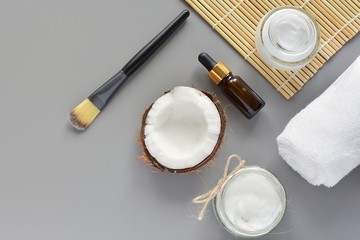 Natural beauty, skin care products, coconut oil, cosmetic oil, body lotion, modern flat lay on gray background