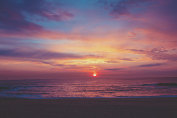 Fototapeta premium Sunset over the ocean. Sandy beach at sunset. Beautiful seashore in the evening. Porto, Portugal, Europe