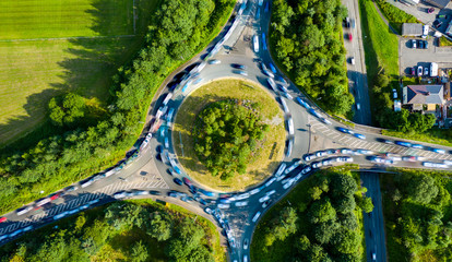 Composite aerial image of traffic using a small roundabout with multiple connecting roads