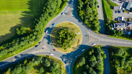 Aerial long exposure of traffic on a roundabout in a small town
