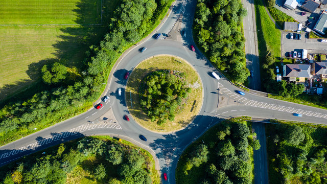 Aerial long exposure of traffic on a roundabout in a small town