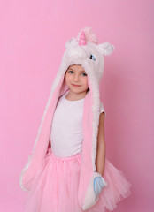  caucasian beautiful little girl in a hat with  unikorn