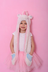  caucasian beautiful little girl in a hat with  unikorn