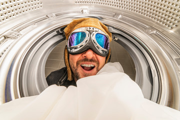 washing machine and spin. Man with aviator glasses, quick wash concept. Interior of washing machine...