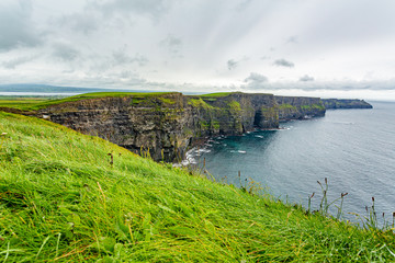 Spectacular view of the Cliffs of Moher, geosites and geopark, Wild Atlantic Way, wonderful cloudy spring day in the countryside in county Clare in Ireland