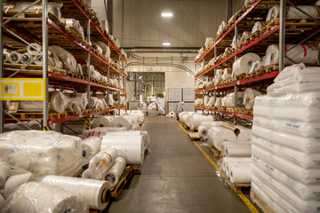 Warehouse of modern chemical production factory with rolled polyethylene film