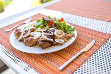 Healthy meal, plate full of chicken meat and fresh salad with tomato, paprika, onions and arugula