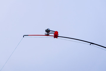 daylight. fishing. feeder abandoned in the river. bells in the center of the frame.