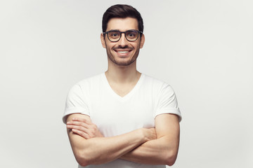 Eyewear fashion. Portrait of handsome young man in casual white t-shirt and trendy eyeglasses,...