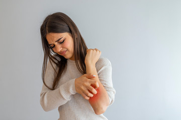 Woman Scratching an itch on white background . Sensitive Skin, Food allergy symptoms, Irritation....