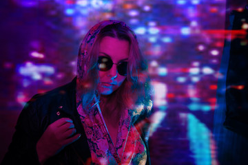 young woman wearing metal jacket in neon lights