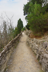 Golitsyn trail in the village of Novy Svet, Crimea. From the sea fence of branches - fence. Cloudy day in early spring