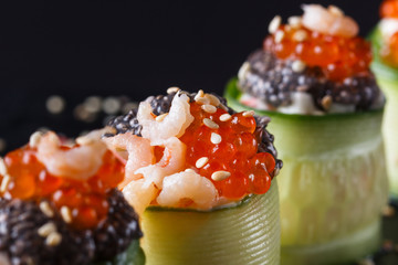rolls covered in cucumber with caviar and prawn