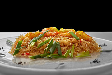 Pilaf with shrimp on a white plate