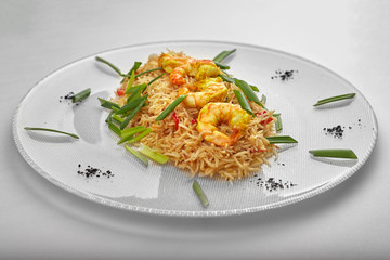 Pilaf with shrimp on a white plate