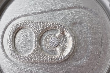 top of the aluminum jar, with the opener covered with condensate, close up
