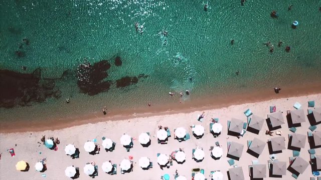 Beach with sun loungers on the coast of the ocean