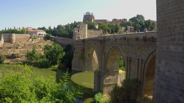  Toledo Spain medieval stone bridge over river_city wall_bird and people-sunny day