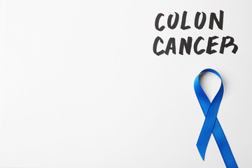 Image of dark blue colon cancer ribbon on white background from Pikwizard