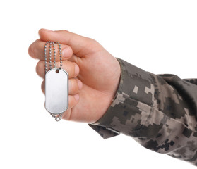 Man in camouflage uniform holding military ID tag on white background, closeup