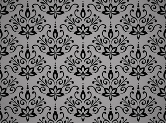 Wallpaper in the style of Baroque. Seamless vector background. Black and grey floral ornament. Graphic pattern for fabric, wallpaper, packaging. Ornate Damask flower ornament