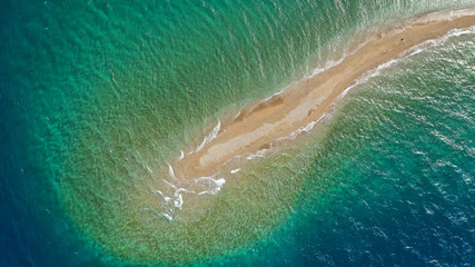 Aerial drone photo of tropical exotic island sand bar separating sea in two with turquoise and sapphire breathtaking colours
