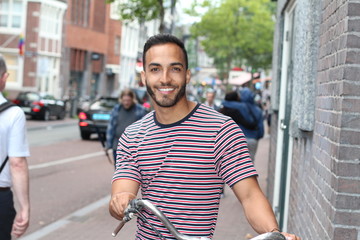 Healthy man using a bicycle in crowded city