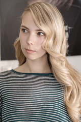 Fototapeta premium Blonde girl with long hair with wave hairstyle