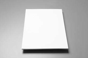 Blank paper sheets for brochure on grey background. Mock up
