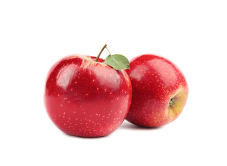 Ripe juicy red apples with leaf on white background