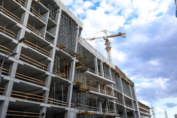 Unfinished building against blue sky. Construction safety rules