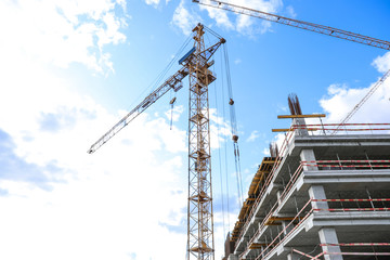 Unfinished building against blue sky. Construction safety rules