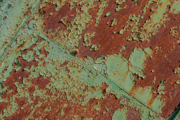 surface of rusty iron with remnants of old paint, grunge metal surface, chipped paint, green texture, background