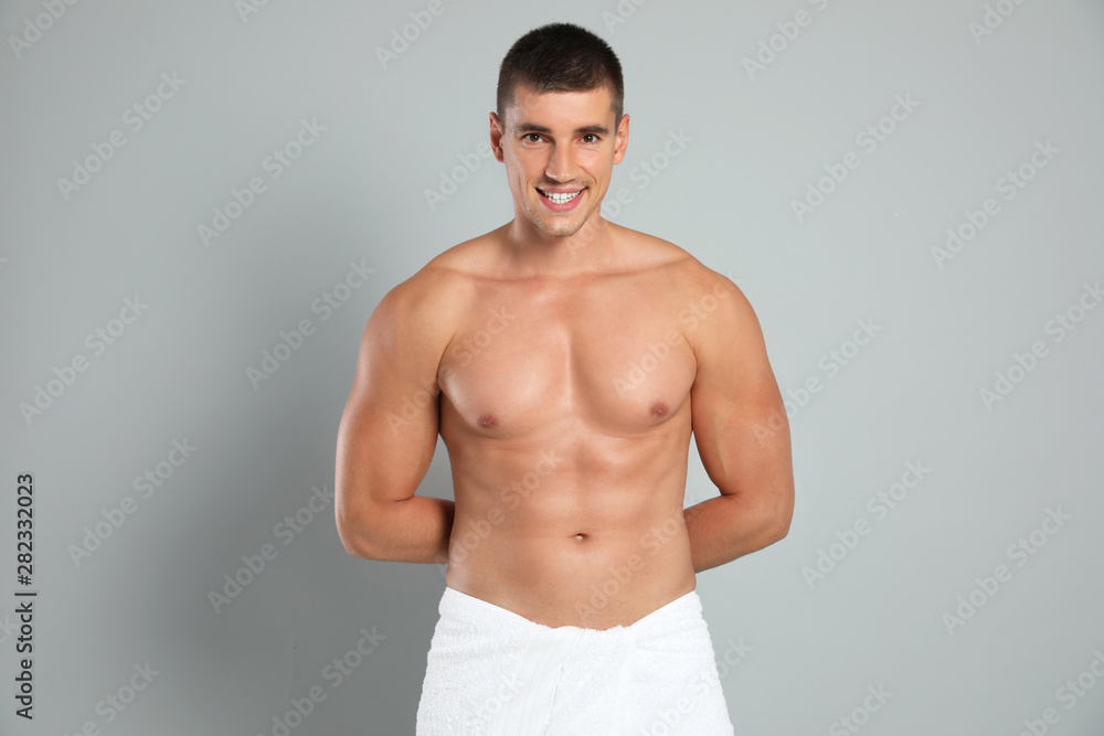 Poster Young man with slim body on grey background