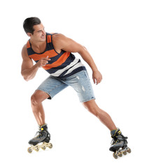 Handsome young man with inline roller skates on white background
