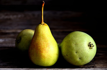 Pears lie on old oak boards.