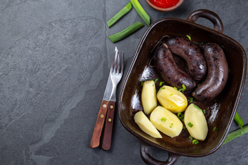 Chilean bloody sausages PRIETA with potatoes and sauce, Top View
