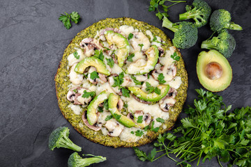 Green broccoli dough crust pizza with avocado, cheese. Low carbs, ketogenic diet vegan vegetarian...