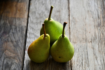 Pears lie on old oak boards.
