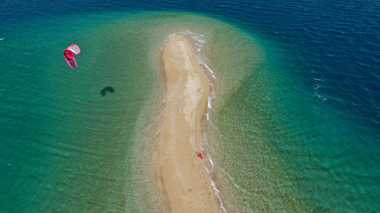 Aerial drone photo of kite surfers practising in tropical exotic bay with beautiful sand bar separating sea in two turquoise and sapphire parts