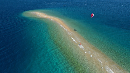 Aerial drone photo of kite surfer practising in tropical exotic sandbar part of island Atoll with...