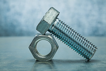 bolt on nut metalic background close up